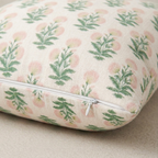 Floral patterned pillow cover with a zipper for easy removal.