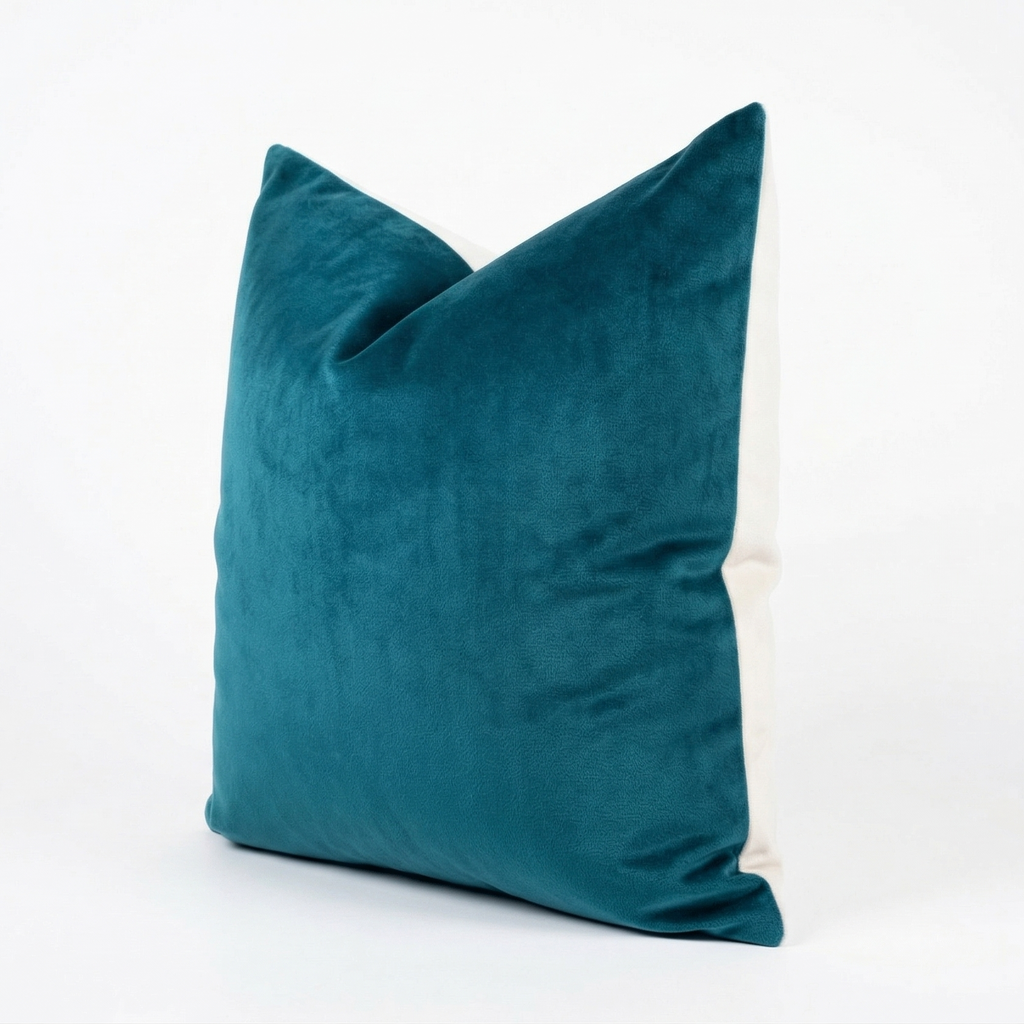 Teal velvet pillow on a white background