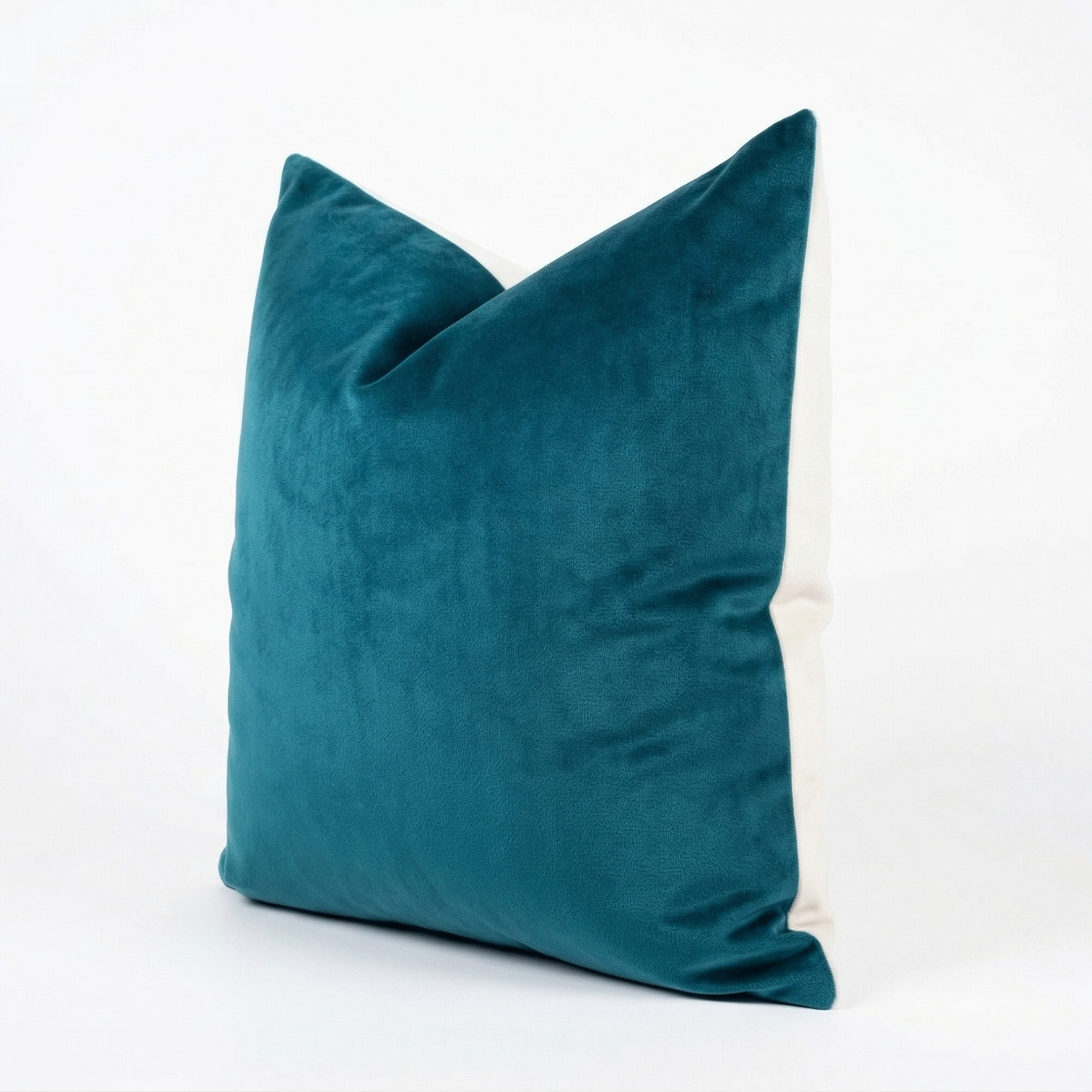 Teal velvet pillow on a white background