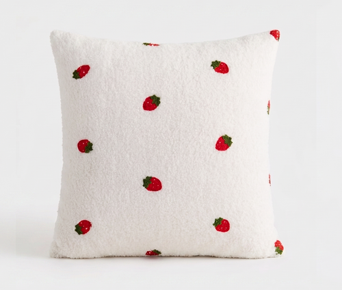 A square white sherpa throw pillow with a pattern of embroidered red strawberries, shown against a plain white background. Pillow cover has a zipper and can be removed and is washable. Insert sold separately. 