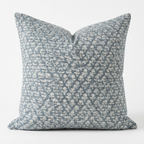 Decorative throw pillow with a blue and white pattern on a white background