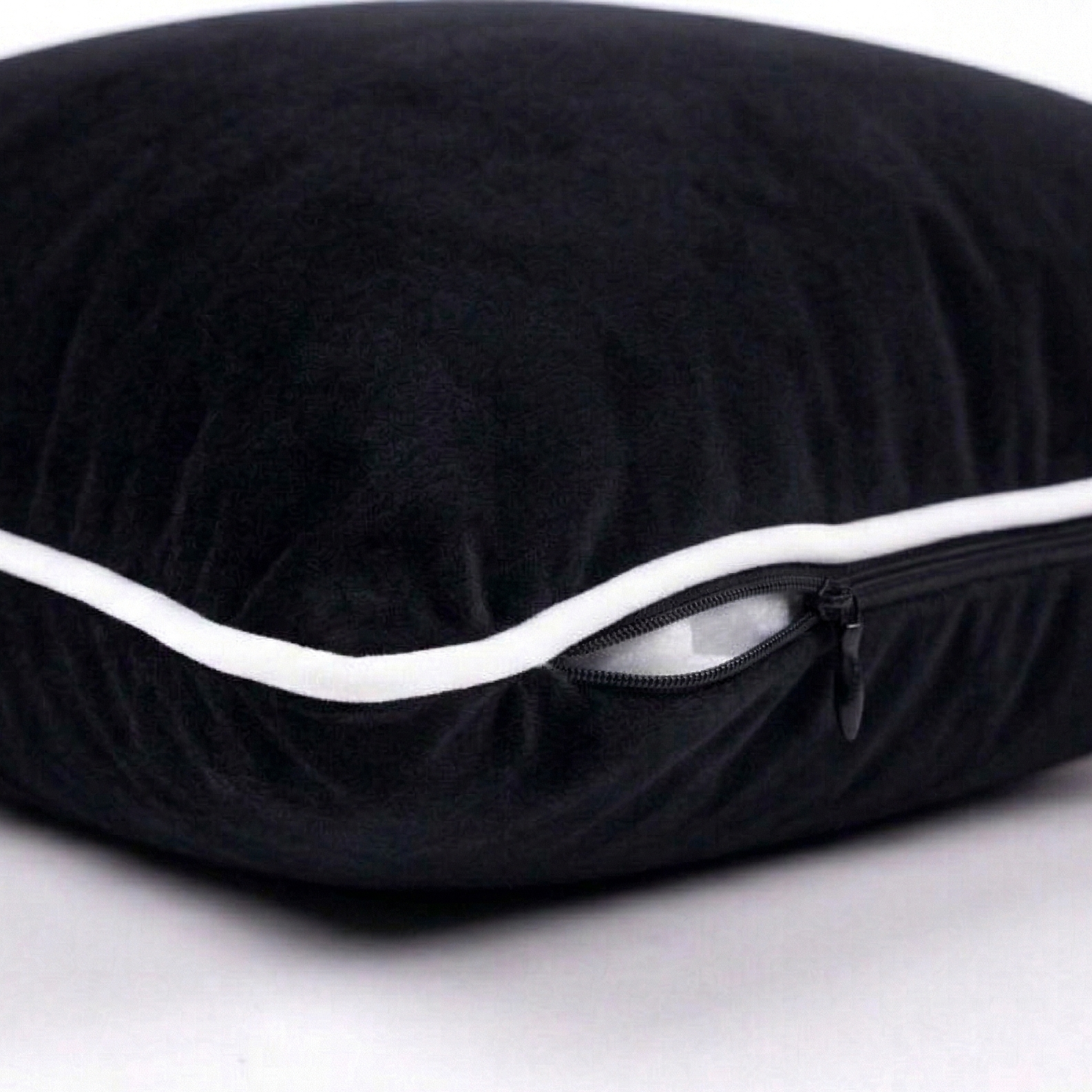 Black velvet pillow with white trim. Featuring side zipper for easy removal.