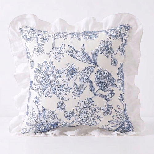 Blue and white floral patterned pillow with ruffled edge on a white background. Pillow cover is removable for easy swapping and washing.