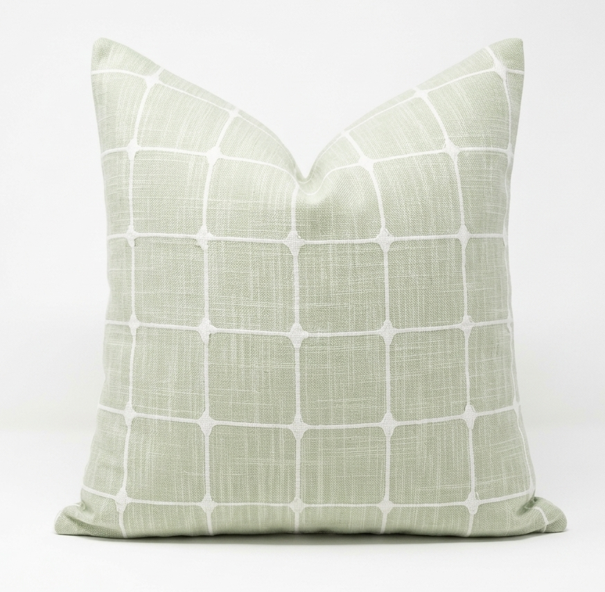 Throw pillow green with white grid pattern. Pillow features removable cover.