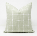 Throw pillow green with white grid pattern. Pillow features removable cover.