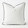 White velvet removable pillow cover with black piping on a white background