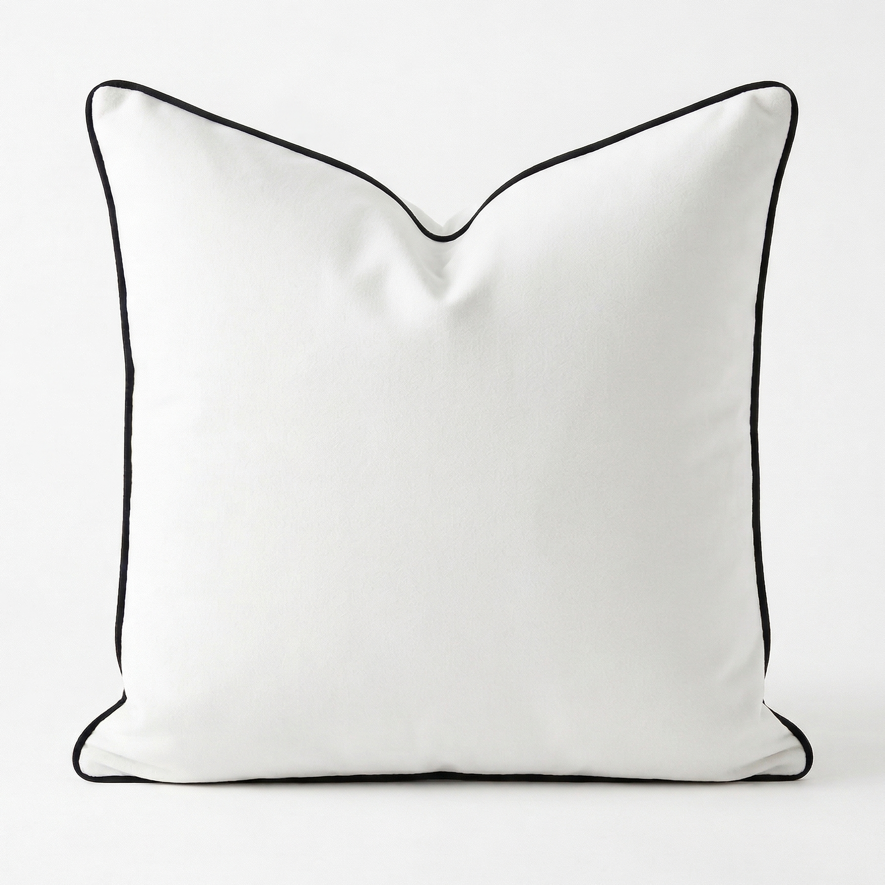 White velvet removable pillow cover with black piping on a white background