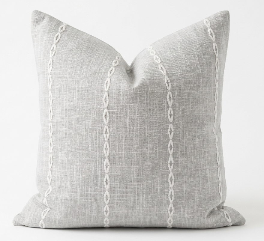 Gray pillow with white chain pattern on a white background