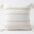 Decorative pillow with tassels on a white background. Pillow cover is removable for easy washing.