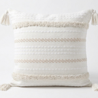 Decorative pillow with tassels on a white background. Pillow cover is removable for easy washing.