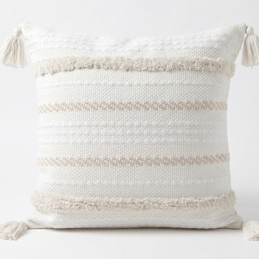 Decorative pillow with tassels on a white background. Pillow cover is removable for easy washing.