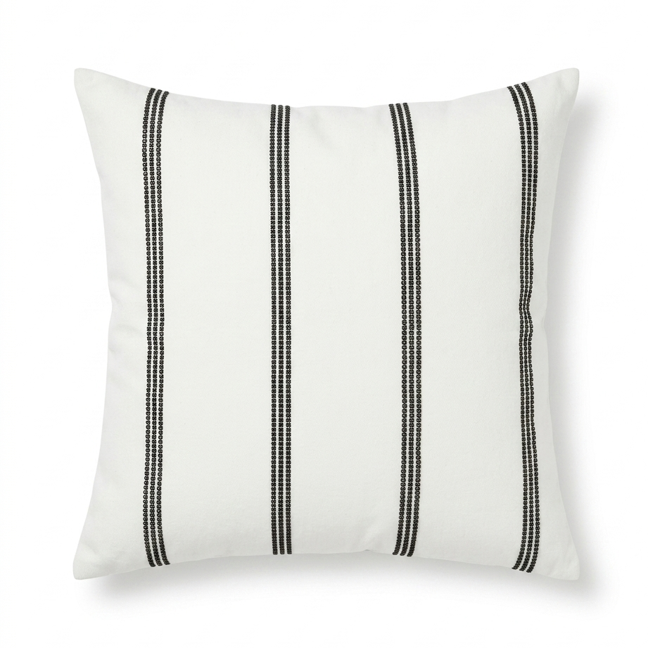 White pillow with black stripes on a white background