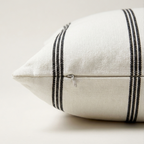 White pillow with black stripes showing off side zipper.