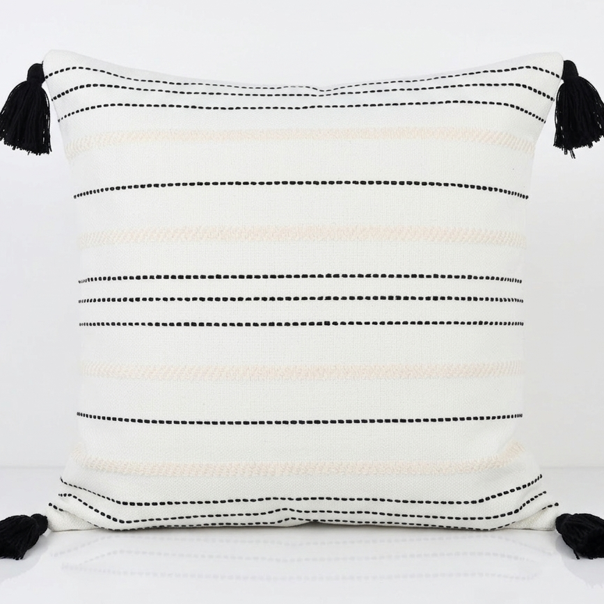 White decorative pillow cover with cream and black stripes and black tassels. Removable throw pillow cover for easy swapping and washing.
