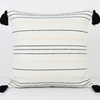 White decorative pillow cover with cream and black stripes and black tassels. Removable throw pillow cover for easy swapping and washing.