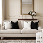 Beige sofa with velvet black and white pillows in a stylish living room. Pillows feature removable covers for easy swapping and cleaning.